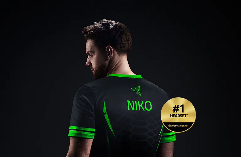 A man in a black and green esports jersey with "NIKO" on back, facing left, against a black background, with a "#1 Headset" badge.