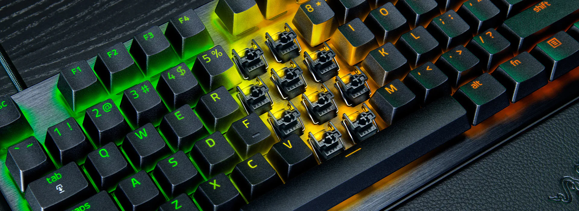 Mechanical keyboard with RGB backlighting, some key switches removed, revealing mechanical components beneath.