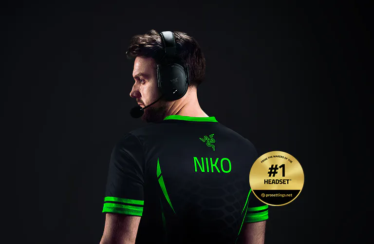 Side view of a man wearing a gaming headset, sports jersey with "NIKO" on the back, and a gold badge stating "#1 HEADSET."