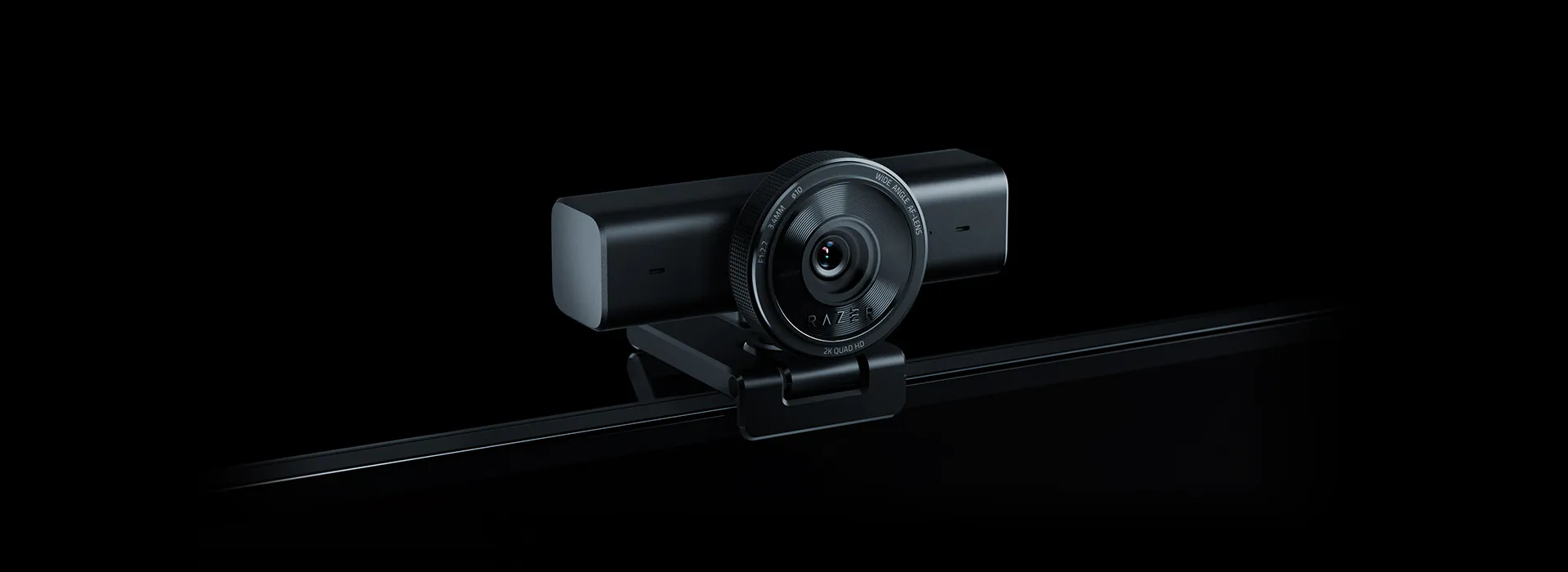 A sleek, black dashboard camera with a prominent lens, mounted on a rail, labeled "RAZER" with "2K QUAD HD" and "WIDE ANGLE" written on it.