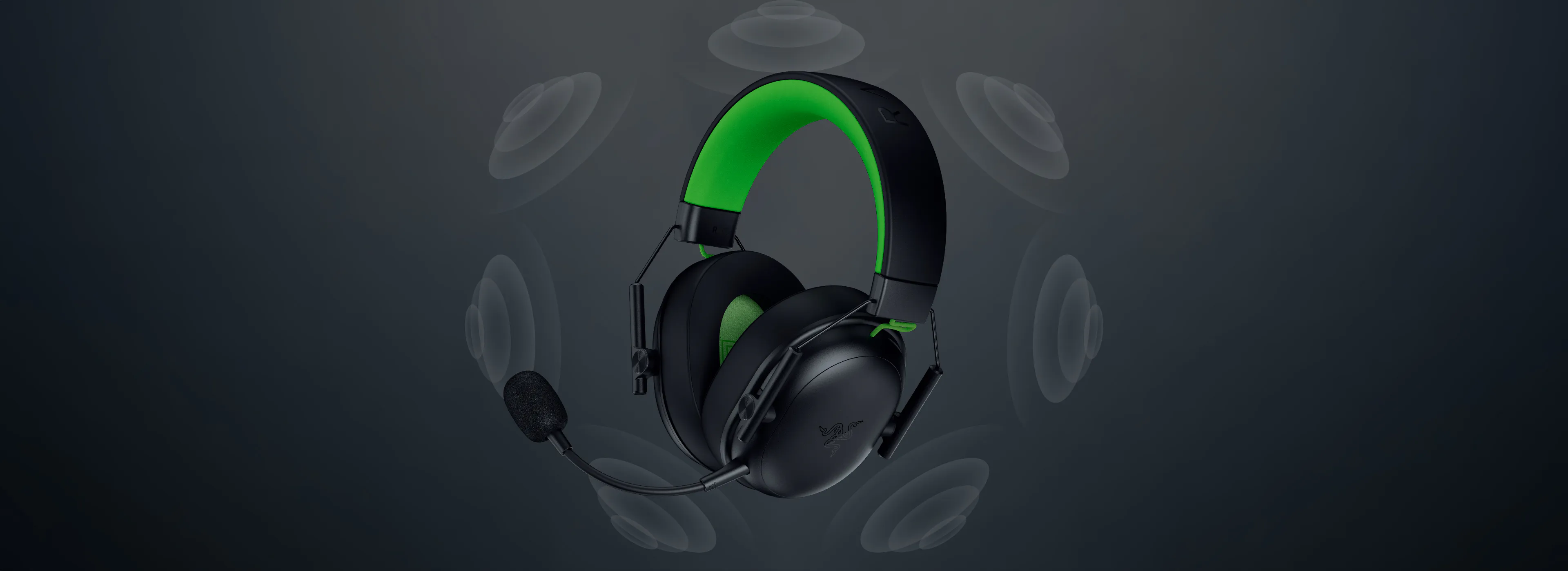 Headset wireless gaming headset with black and green design, 麦克风, and surrounding sound waves, on a dark background.