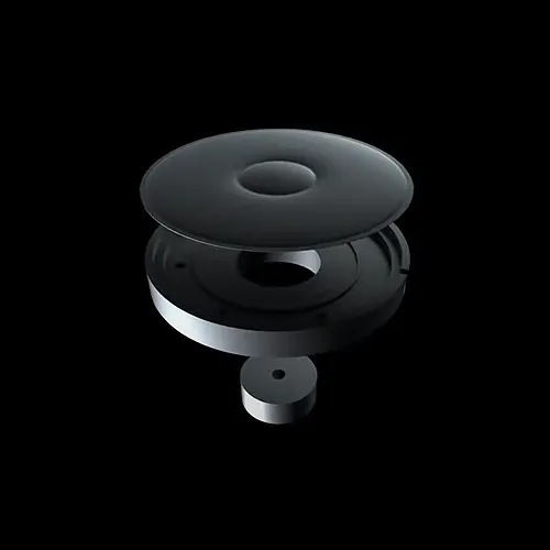 A black, abstract, layered donut-shaped object with hollow centers, resting on a black background, resembling a modern sculpture or mechanical component.