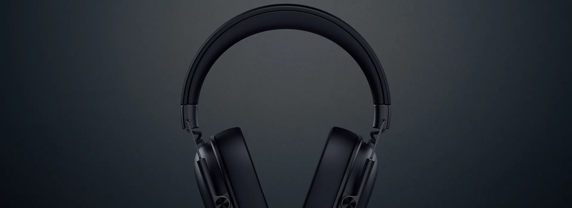 Wireless black headphones with a sleek design, set against a dark gray background. No visible text in the image.