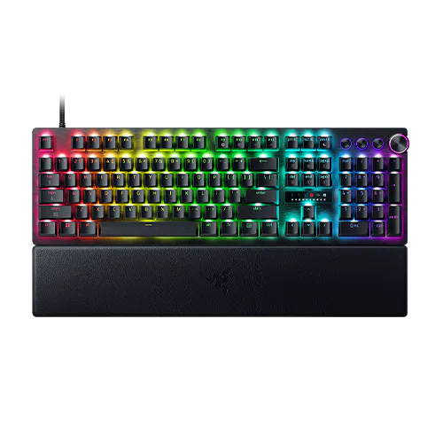 RGB backlit gaming keyboard with a wrist rest, featuring multicolor illuminated keys, standard layout, and a volume control knob on the top right.