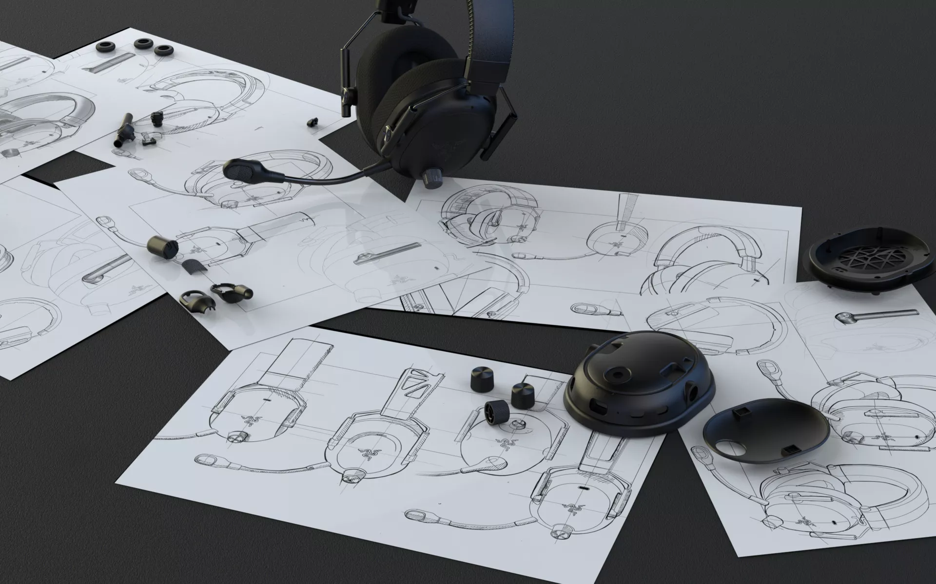 Deconstructed headset components laid out on top of detailed product design sketches, showing the development process of a Razer gaming headset.