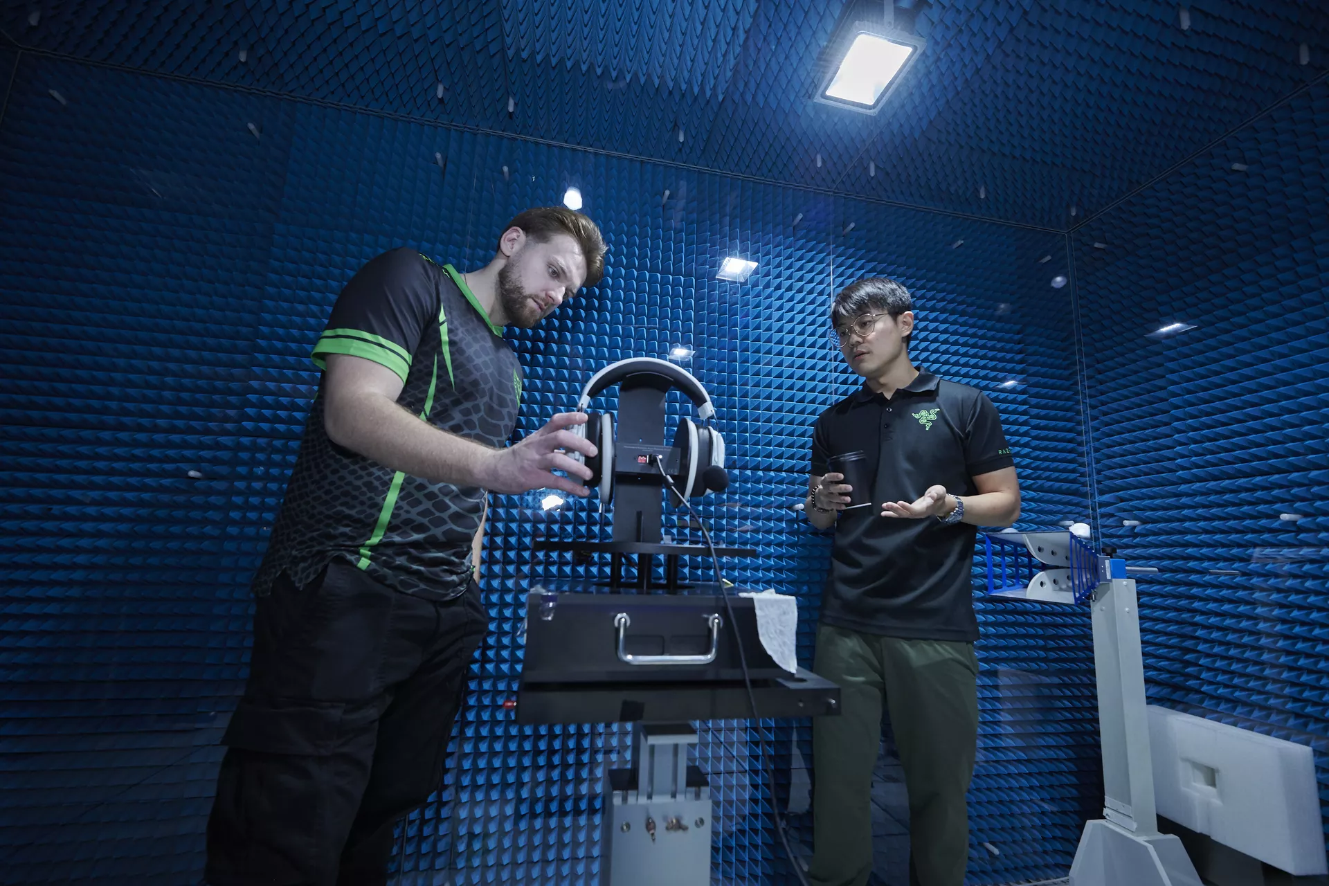 NiKo evaluate a gaming headset inside an anechoic chamber designed for acoustic testing and sound isolation measurements.