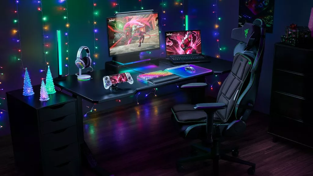 Holiday-themed gaming setup featuring Razer Phantom White peripherals, a Razer Iskur gaming chair with the Razer Freyja, and festive Razer Chroma RGB lights.