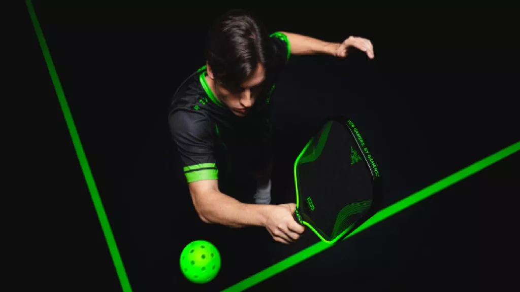An athlete wearing the Team Razer jersey playing pickleball with the Razer x JOOLA Perseus Pro IV 16mm.