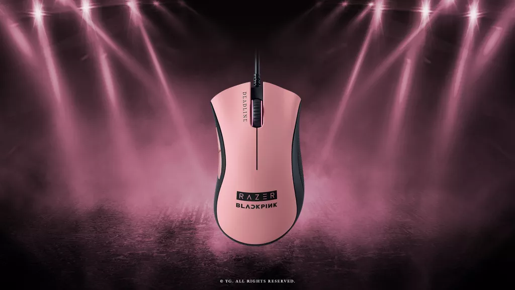 Razer DeathAdder Essential – BLACKPINK Edition gaming mouse in pink, shown under stage lighting inspired by the BLACKPINK World Tour .