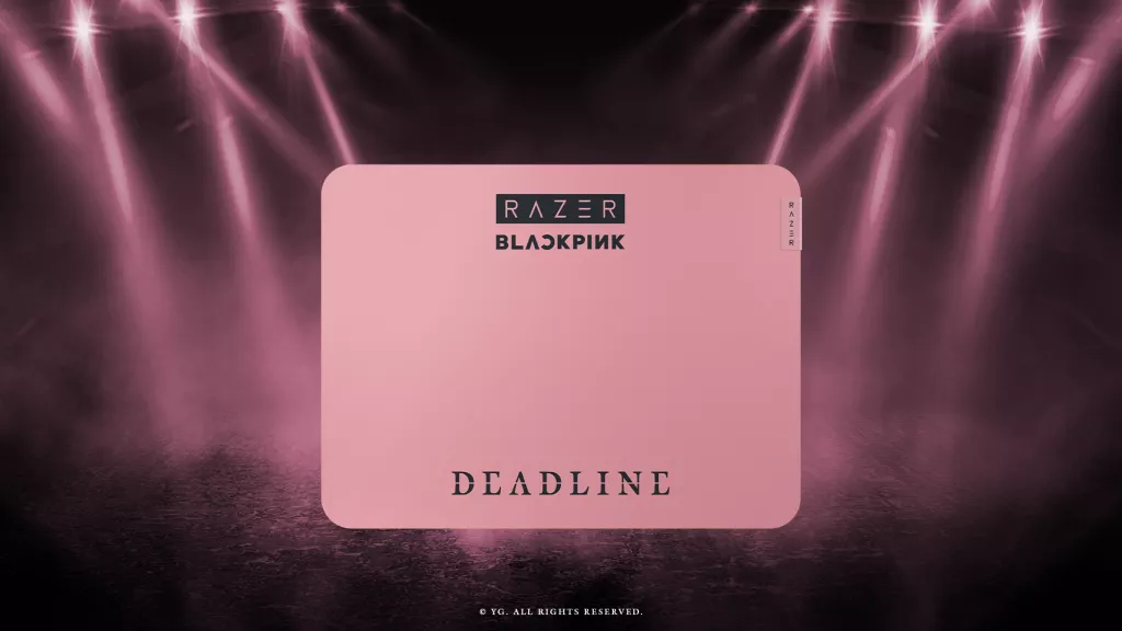 Razer Gigantus V2 – BLACKPINK Edition mousemat in pink, shown under stage lighting inspired by the BLACKPINK World Tour .