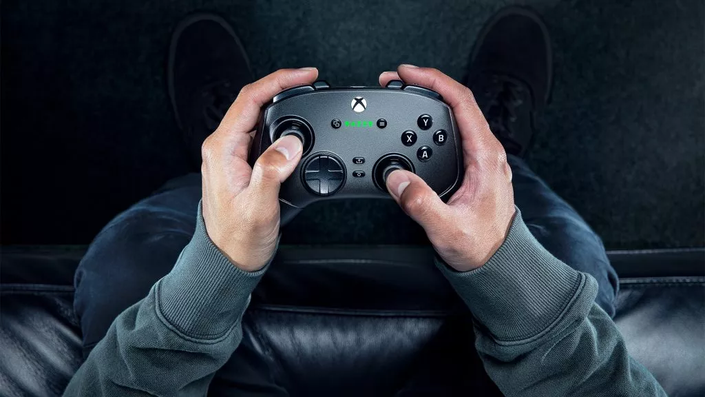 Razer Wolverine V3 Pro controller in use with hands holding the device.