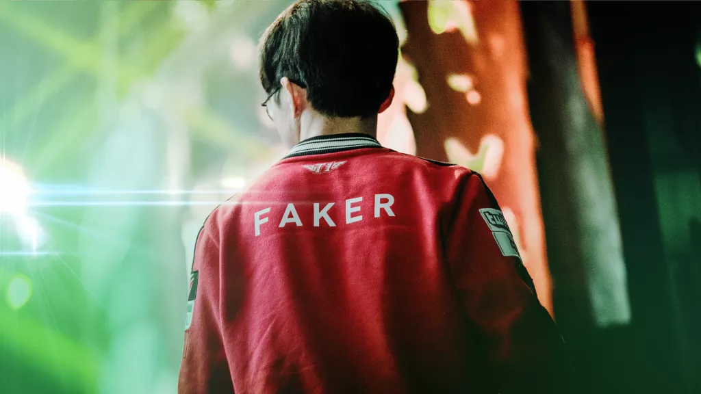 Faker wearing his T1 jersey with name visible, walking toward stage lights during an esports event.