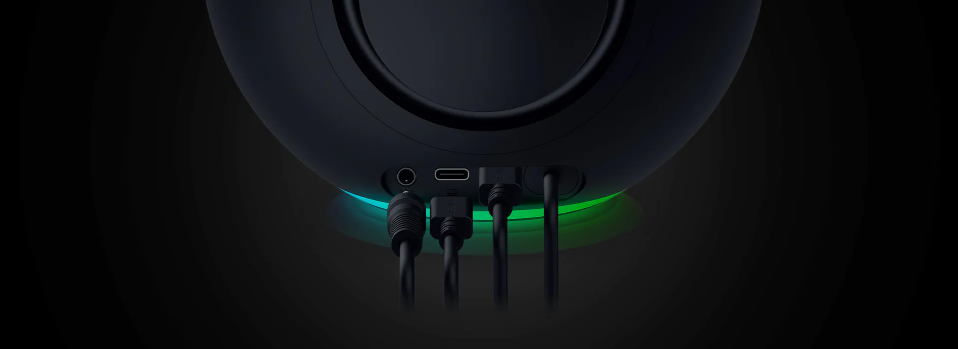 A close-up of a black speaker with four input ports, LED light ring, and text "INPUT" near the ports, set against a dark background.