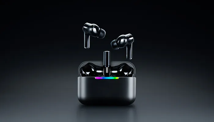 Wireless earbuds in black with charging case, floating above a dark background, with a small rainbow-colored indicator light.