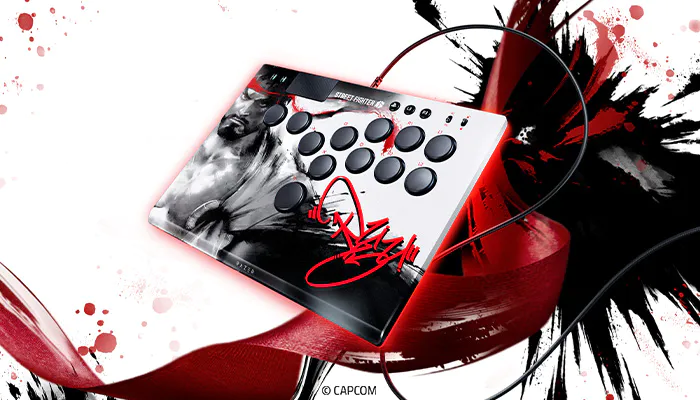 Arcade fight stick controller with "Street Fighter" theme, Capcom logo, and signature, featuring multiple buttons on a white, black, and red background.