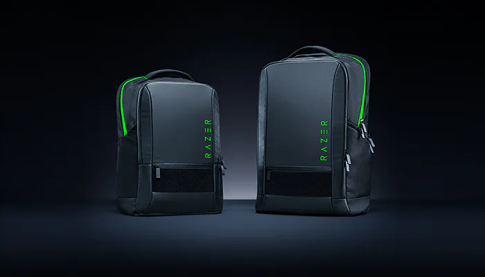 Two black Razer backpacks with green accents and the "RAZER" logo, set against a dark background.