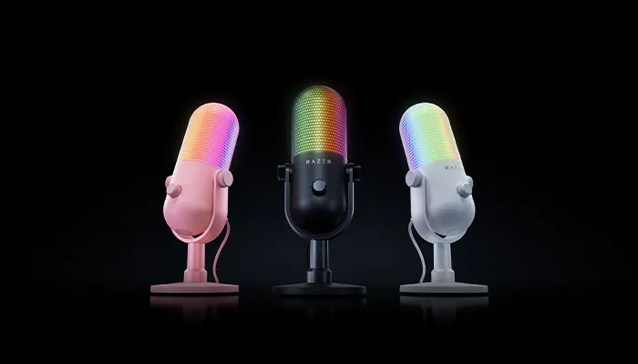 Three Razer microphone models in pink, black, and white with rainbow RGB lighting, positioned against a black background.