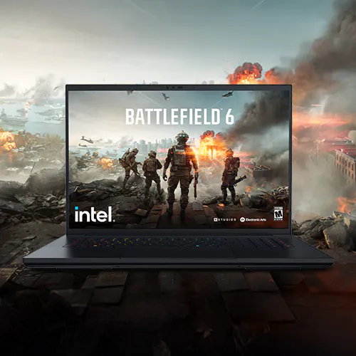 Laptop showing Battlefield 6 game cover, with soldiers in a war-torn battlefield and explosions in the background. "BATTLEFIELD 6" and "intel." text visible.