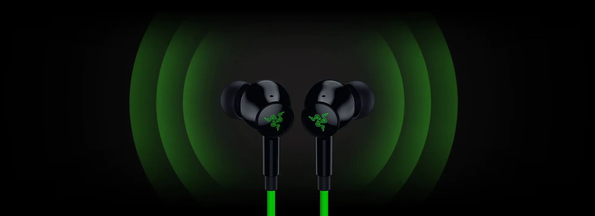 Black Razer earbuds with glowing green logo, emitting green sound waves against a dark background.