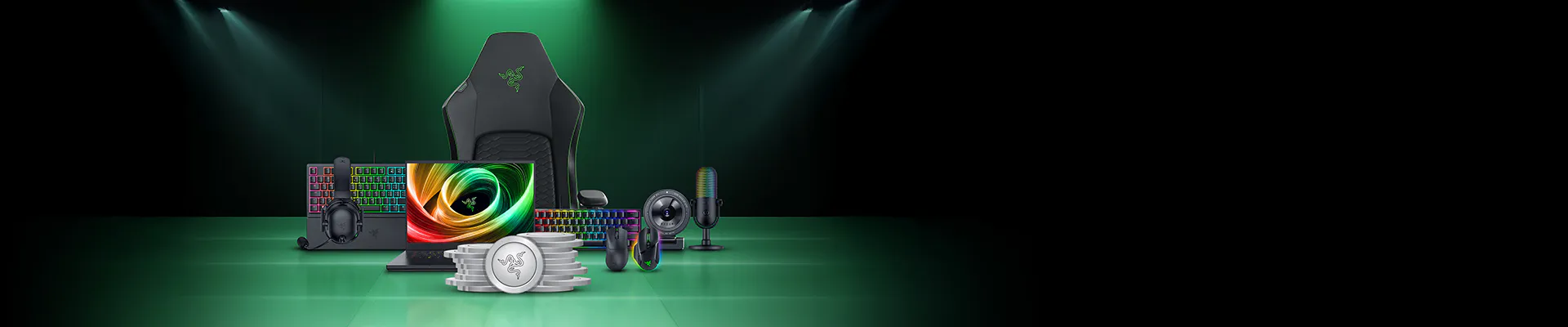 Gaming gear set with chair, keyboard, mouse, headset, mic, monitor, and coins, all on a green floor with a dark background.