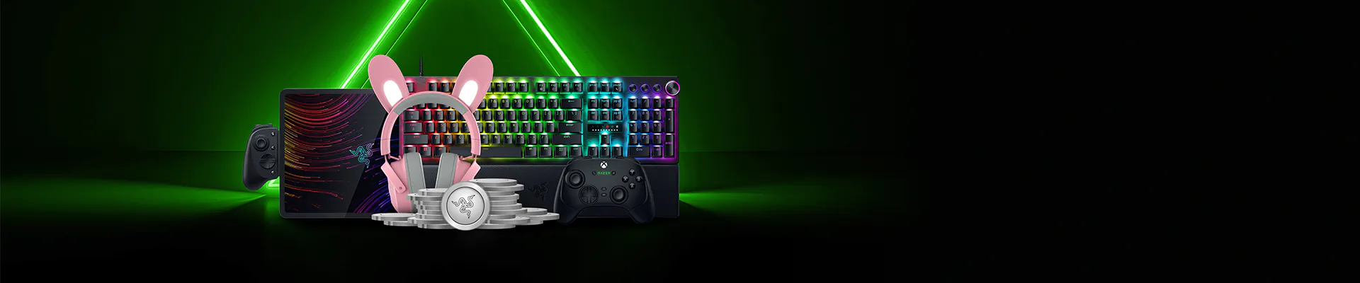 Gaming essentials include a RGB keyboard, controller, headset with bunny ears, gamepad, and stack of coins, set against a black and green neon background.