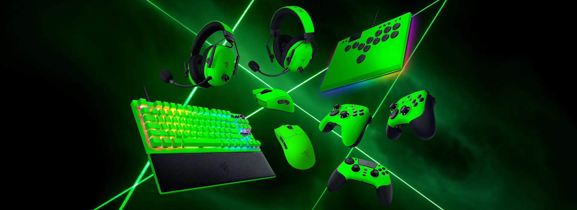 Gaming gear setup: RGB mechanical keyboard, two gaming mice, two controllers, headset, and a pad, all in vibrant green with laser effects.