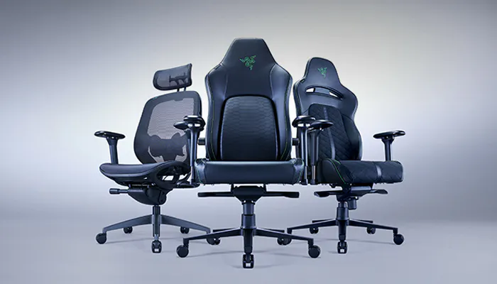 Three gaming office chairs with black mesh and faux leather, featuring adjustable armrests and headrests, against a plain background.