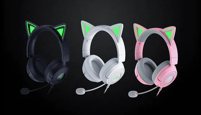 Three gaming headsets with cat ear designs in black, white, and pink, each with glowing green or pink accents on the ears, against a black background.