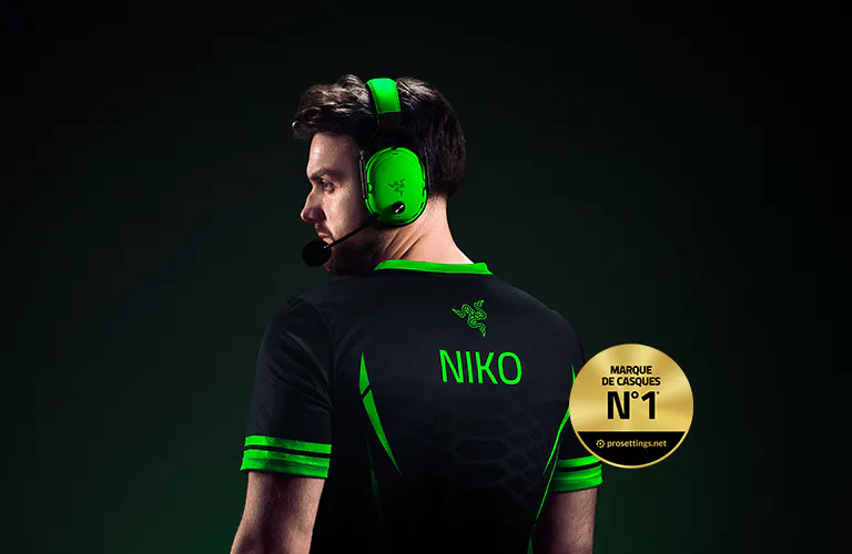 Side view of a man wearing a gaming headset, sports jersey with "NIKO" on the back, and a gold badge stating "#1 HEADSET."