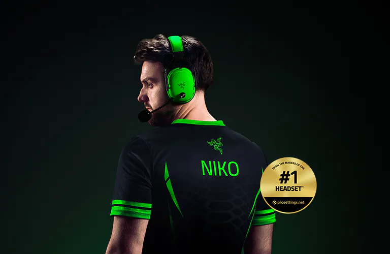 Side view of a man wearing a gaming headset, sports jersey with "NIKO" on the back, and a gold badge stating "#1 HEADSET."