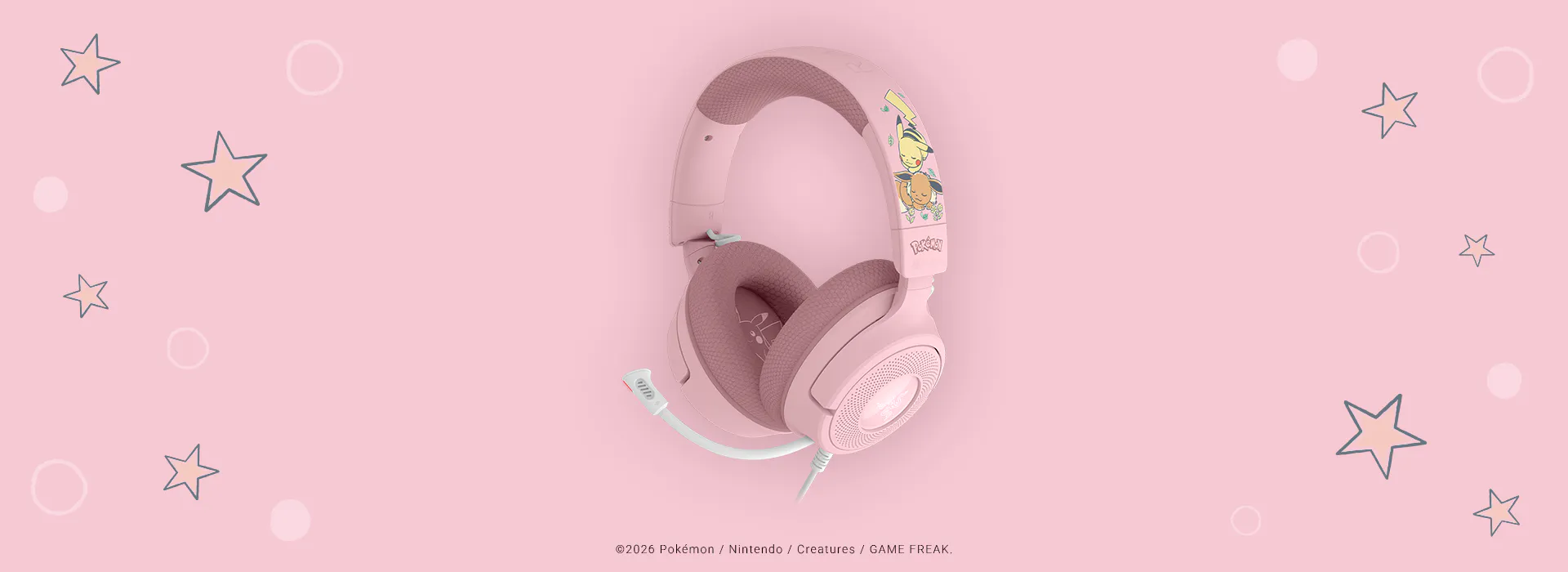Pink Pokémon-themed gaming headset with character artwork, large ear cups, headband, and a white adjustable mic on a pink background.; ©2026 Pokémon / Nintendo / Creatures / GAME FREAK.