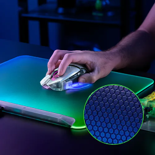 A hand uses a gaming mouse on a glowing RGB mousepad, with a close-up inset of a textured hexagonal-pattern 表面.