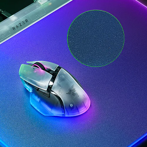A gaming mouse with RGB lighting on a Razer mousepad, featuring a textured 表面 and a circular green outline marking the pad area.