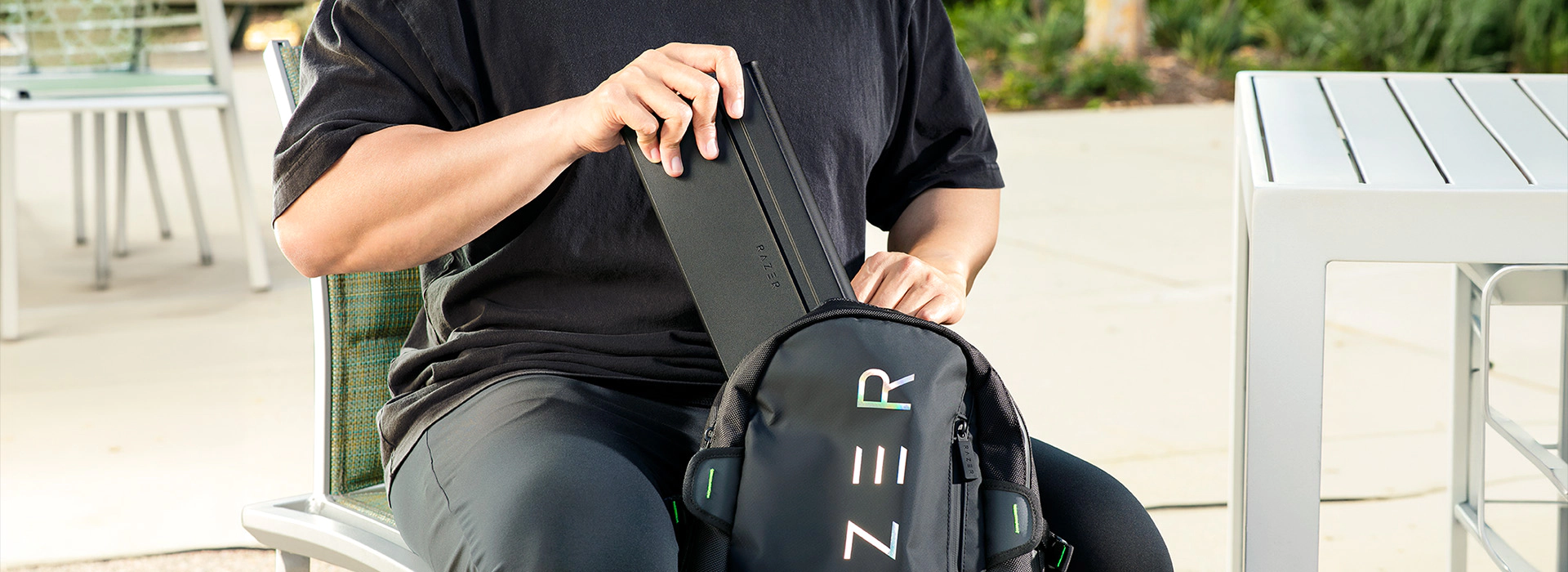 Slim keyboard case being placed into a Razer backpack.