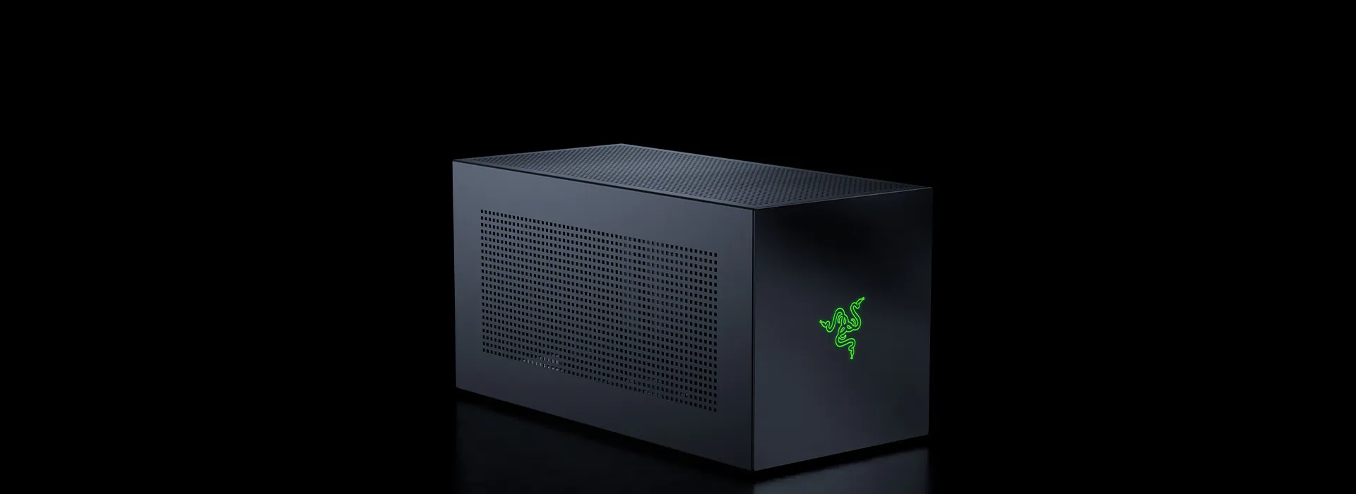 Black Razer gaming PC case with green Razer logo on the front, black perforated side panel, set against a black background.