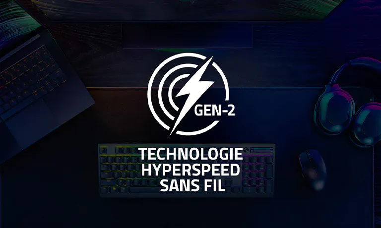 Dark workspace with a laptop, headset, mouse, keyboard, monitor, and overlayed logo "GEN-2" and text "Technologie hyperspeed sans fil."