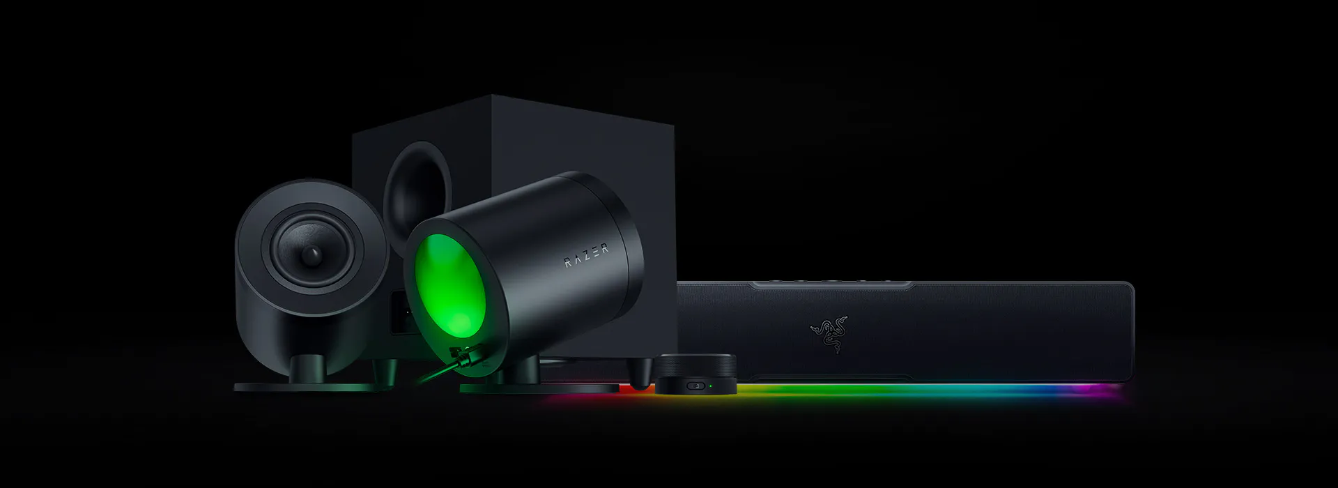 Razer gaming speakers and accessories on a dark background with RGB lighting