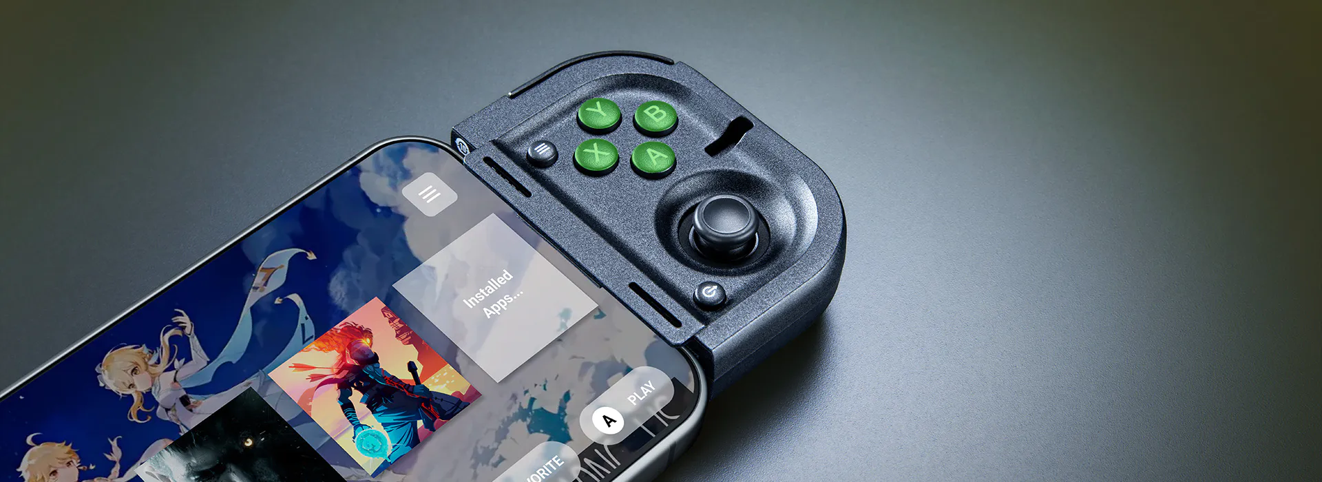 Smartphone with game app installed, connected to a portable game controller with green buttons labeled Y, B, X, A, and a joystick.