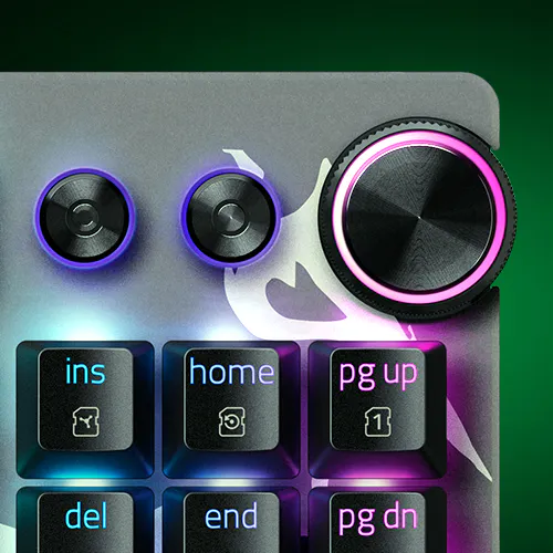 Control panel with two knobs, backlit buttons labeled ins, home, PG up, del, end, PG dn, and a large pink-lit dial, possibly for a keyboard.