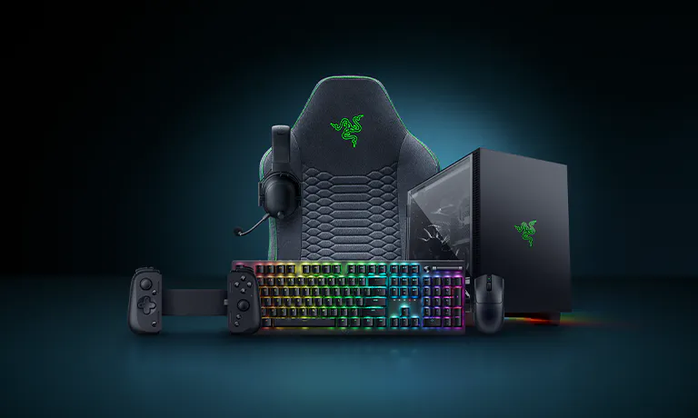 Gaming gear set with a Razer logo: RGB keyboard, mouse, headset, a large chair, and gaming PC, all on a dark background.