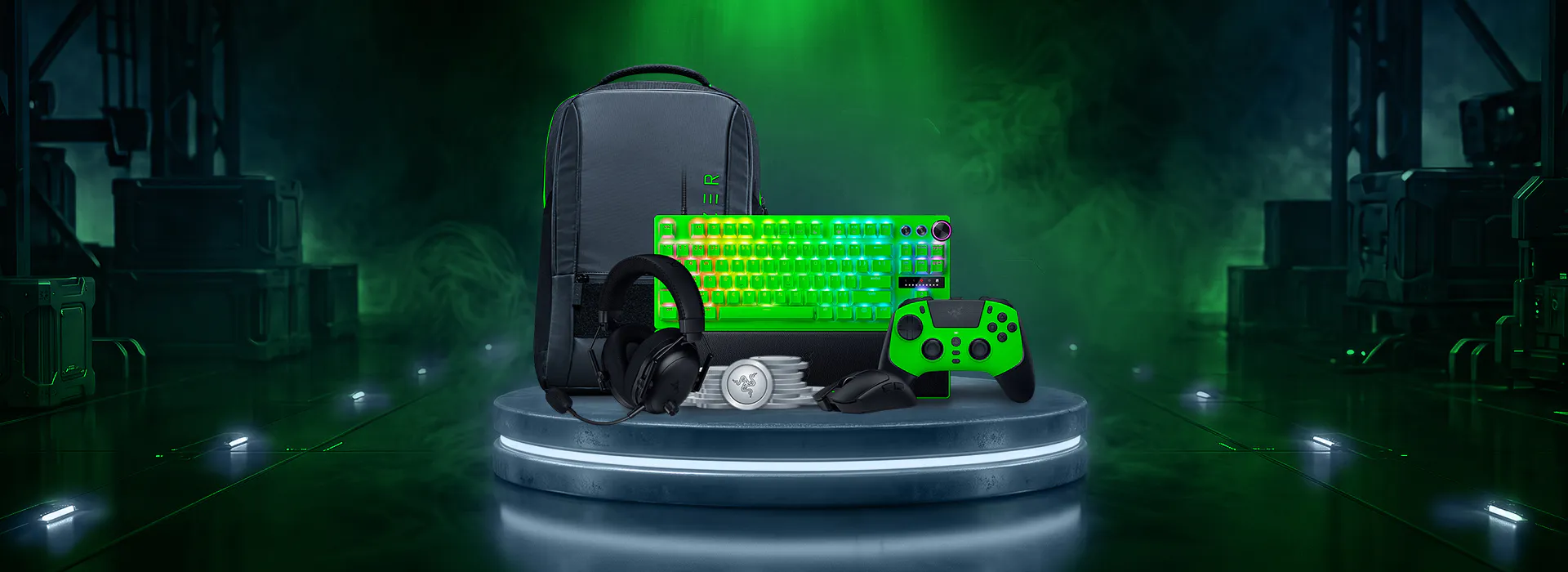 A gaming gear set with a backpack, glowing green keyboard, gaming headset, controller, mouse, and cooling pad, all with green-themed design.