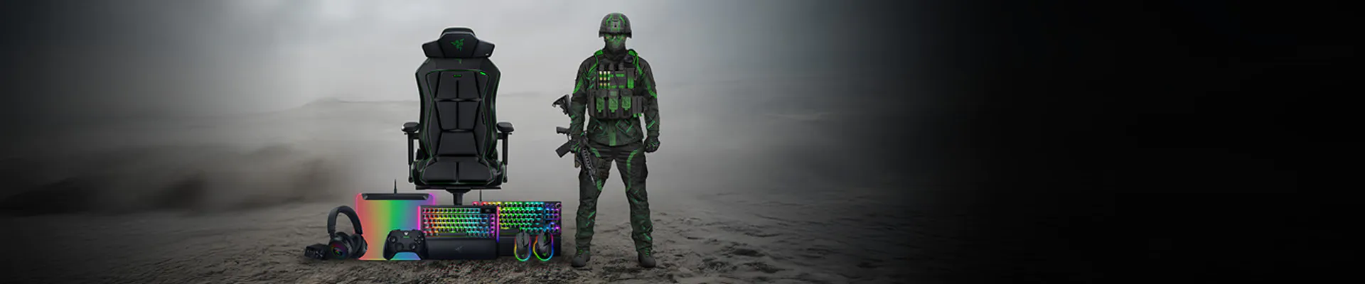 A soldier in black and green gear stands next to gaming equipment, including a chair, keyboard, headset, and colorful gaming devices, on a desert.
