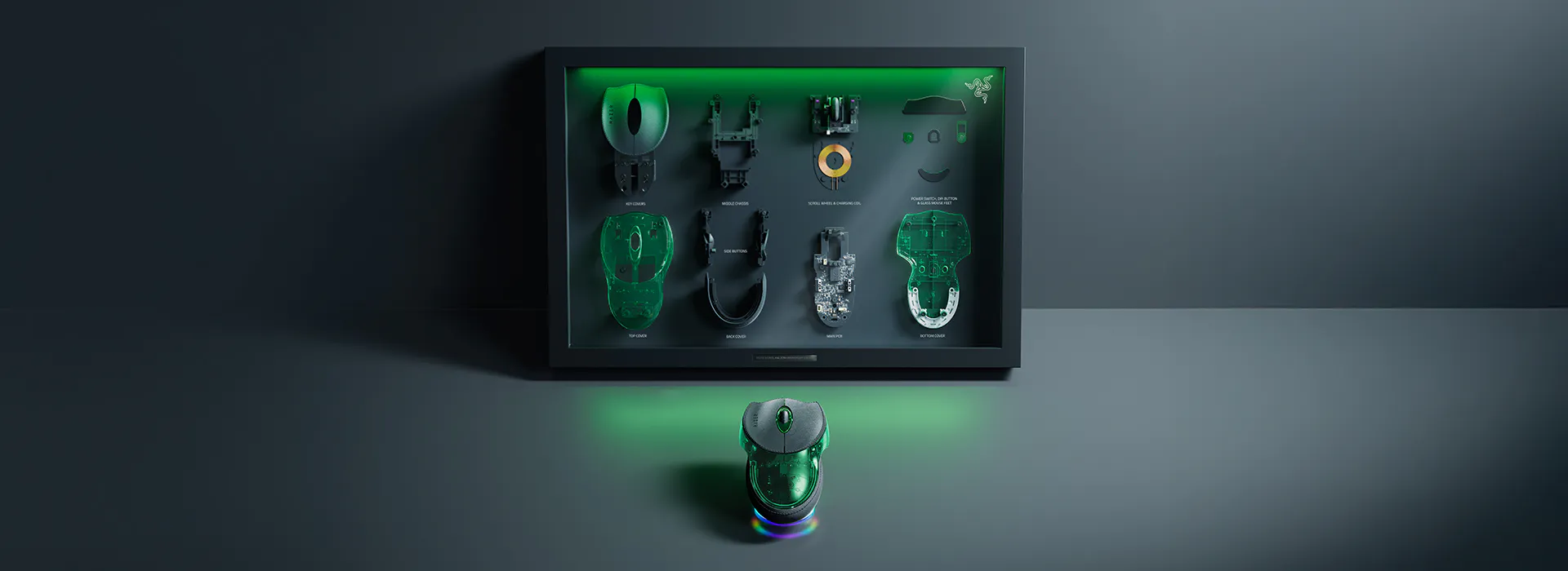 Display of disassembled Razer Boomslang parts with labels: key cover, mouse cover, module OWS, side buttons, main PCB, bottom cover, and power switch.
