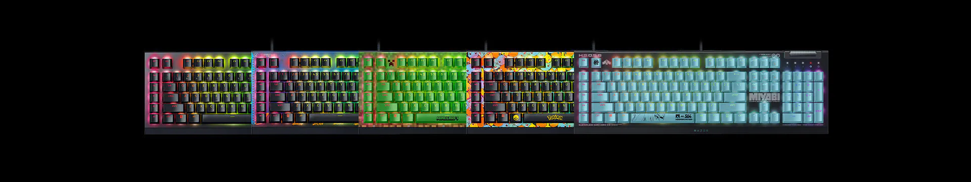 A black keyboard with rainbow-colored, themed, and labeled keys, featuring multiple designs and engraved texts, illuminated with backlighting.